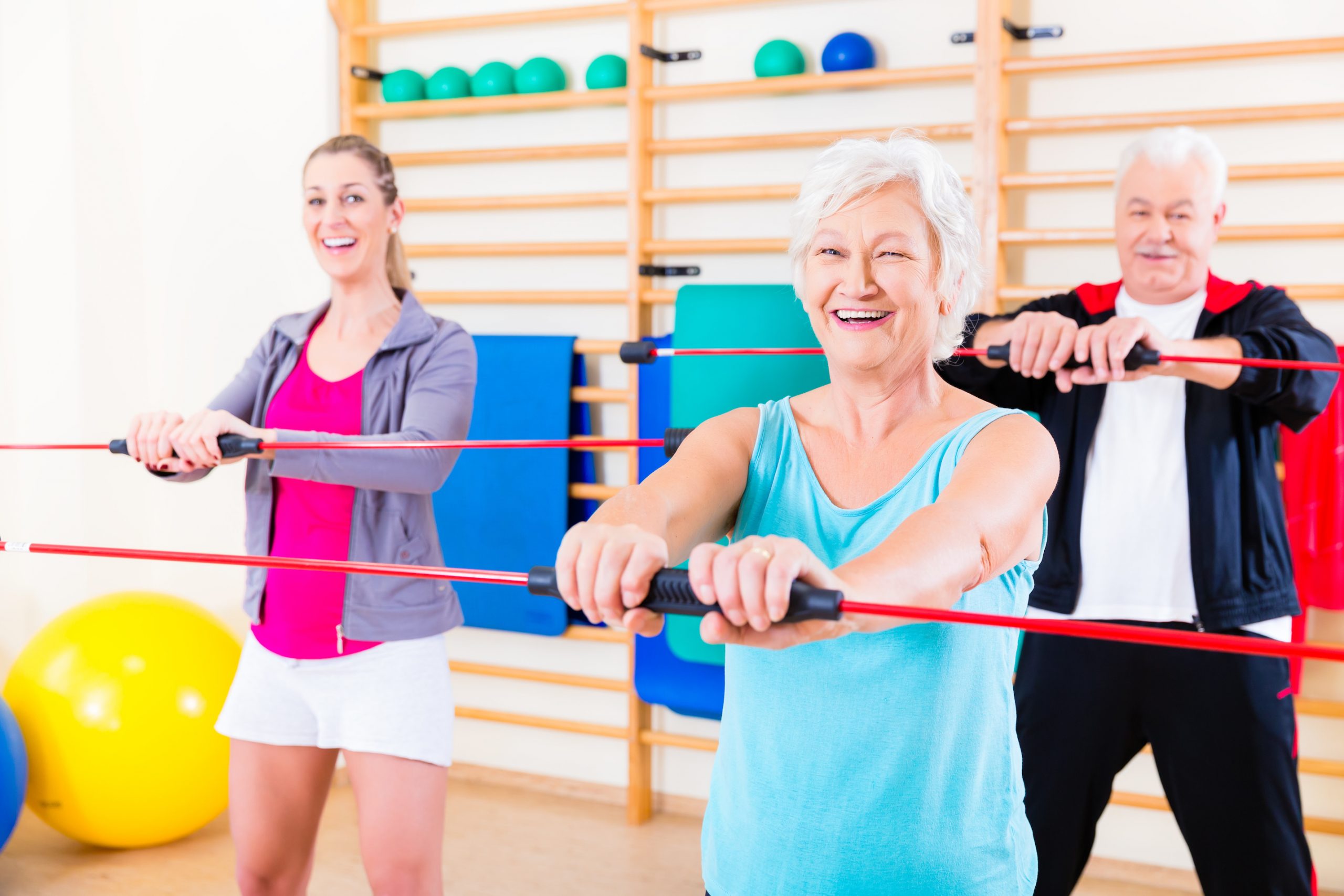 Group at fitness training with gymnastic bar